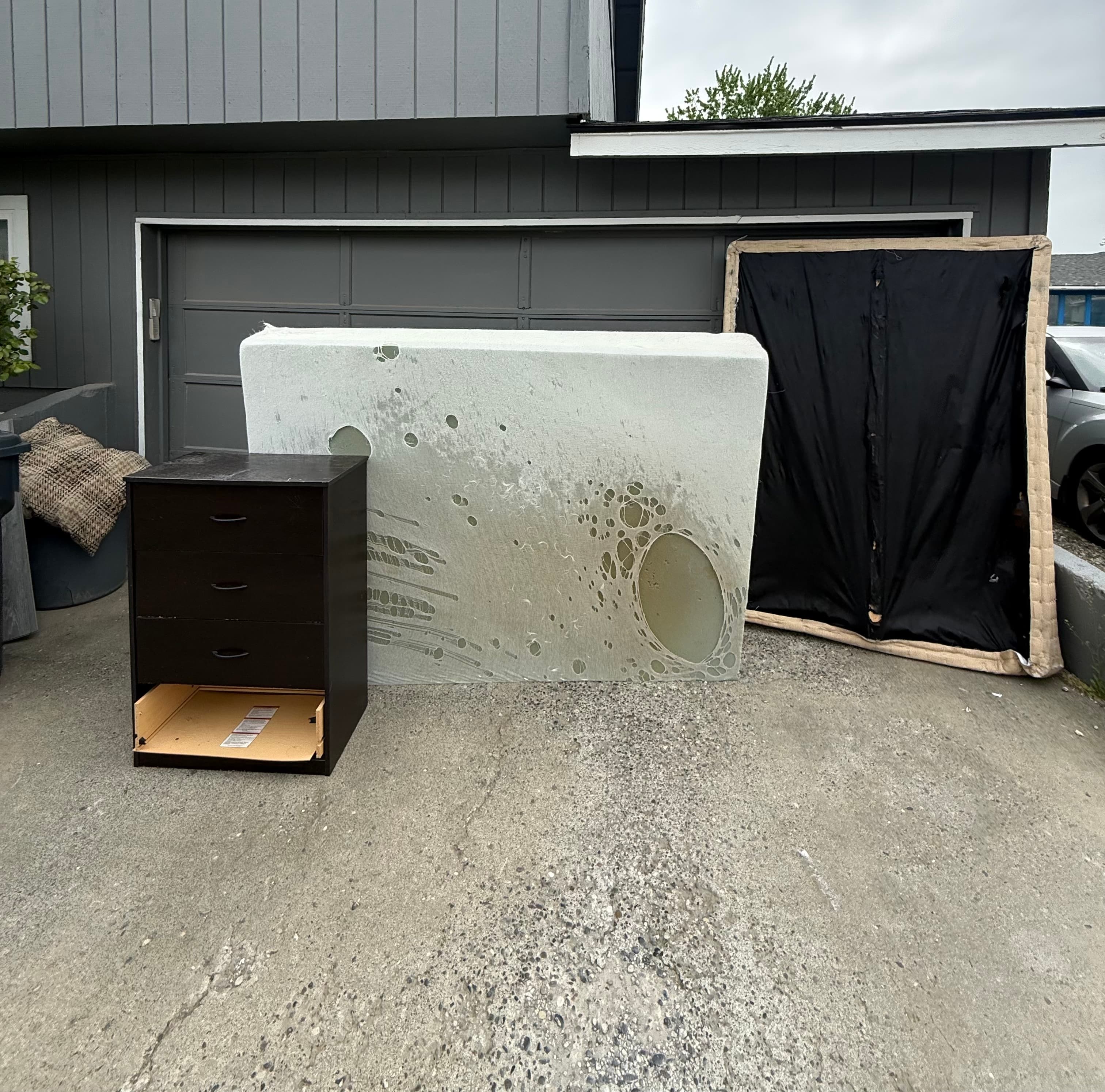 Cluttered driveway before junk removal with debris, trash, and other junk