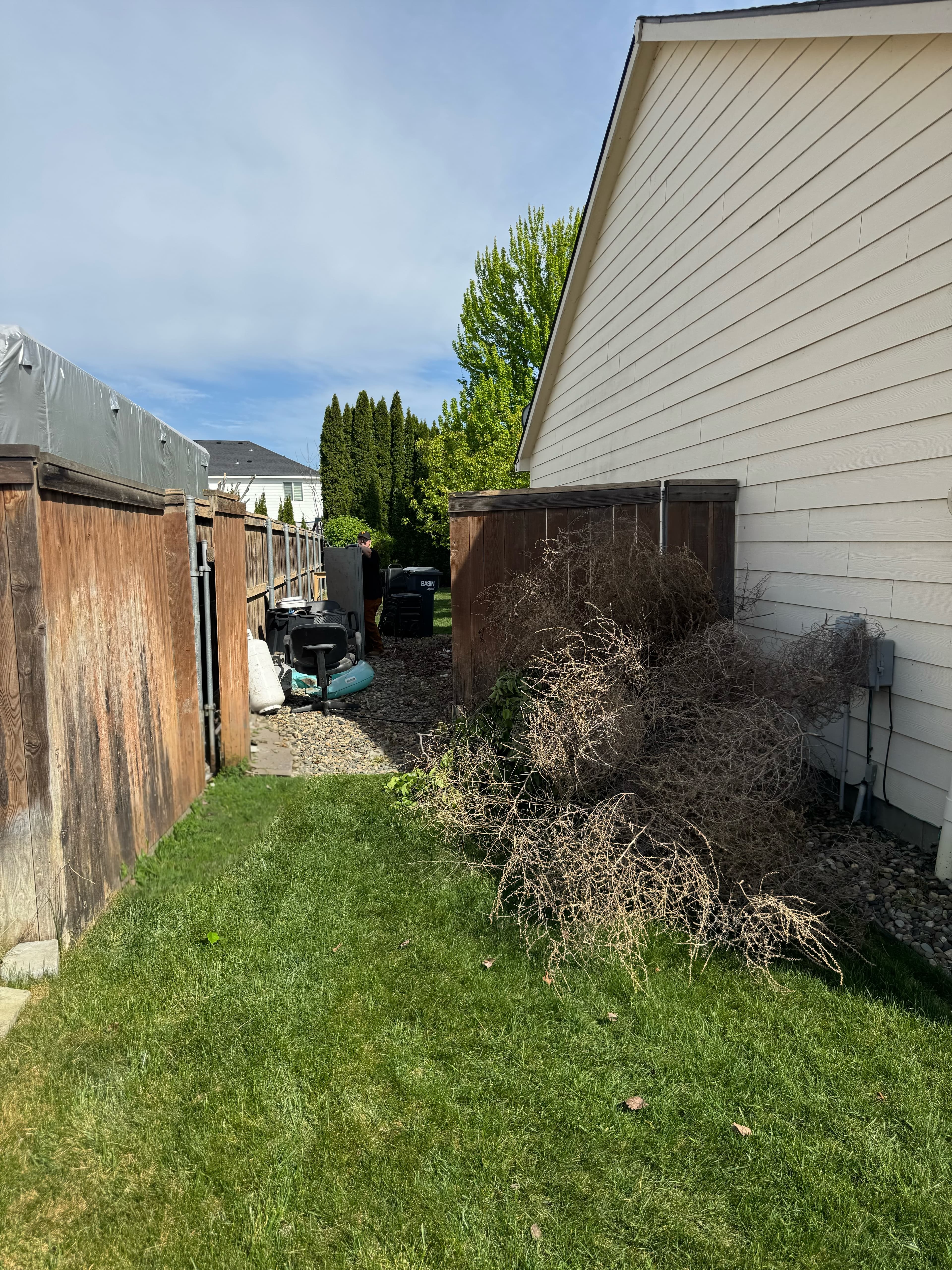 Cluttered outdoor space before junk removal with debris visible